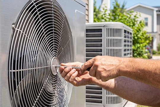 Man repairing AC unit