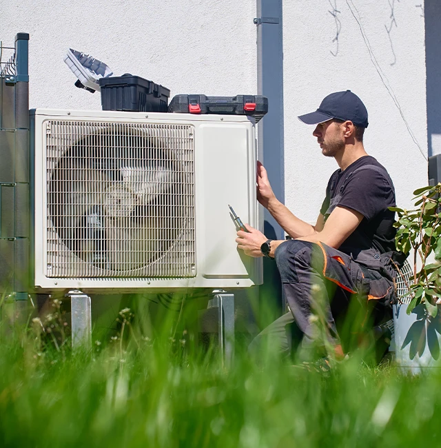 repair man working on air conditioner