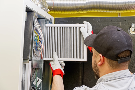 man checking HVAC filter